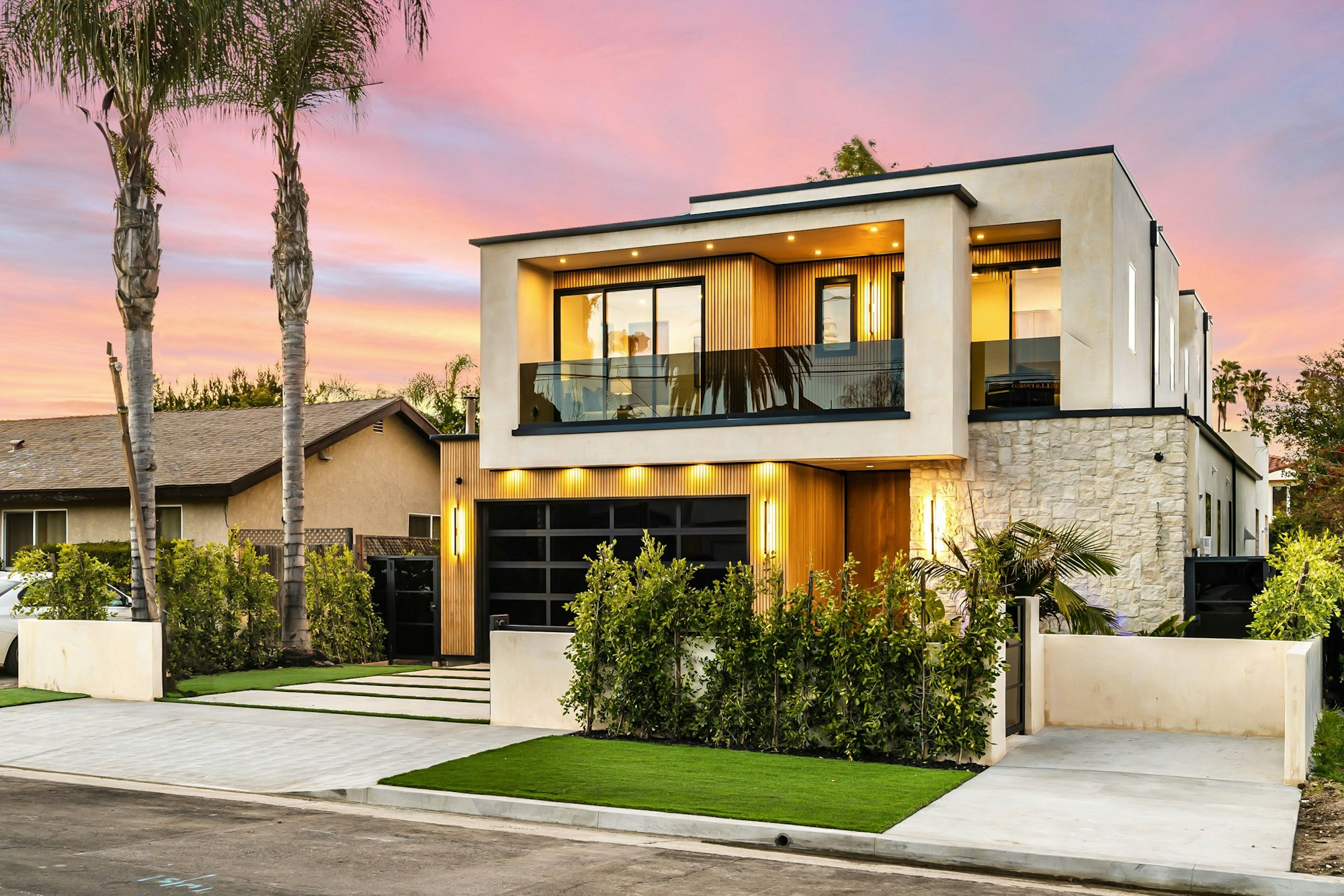 Modern luxury home exterior at sunset.